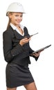 Businesswoman wearing hard hat holding clipboard Royalty Free Stock Photo