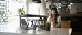 Businesswoman wearing listening music and using mobile phone at office desk. Royalty Free Stock Photo