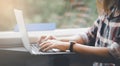 Businesswoman wearing a mask and working on laptop on a train, Asian freelance writer or designer writing emails on computer, work Royalty Free Stock Photo