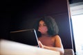 Businesswoman Wearing Mask Working In Socially Distanced Cubicle In Office During Health Pandemic Royalty Free Stock Photo