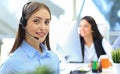 Businesswoman wearing microphone headset using computer in the office - operator, call center. Royalty Free Stock Photo