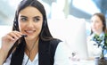 Businesswoman wearing microphone headset using computer in the office - operator, call center Royalty Free Stock Photo