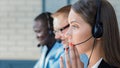 Businesswoman wearing microphone headset using computer in the office - operator, call center Royalty Free Stock Photo