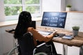 Businesswoman On Wheelchair Analyzing Graph Royalty Free Stock Photo