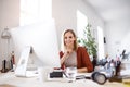 Businesswoman in wheelchair at the desk in her office. Royalty Free Stock Photo