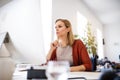 Businesswoman in wheelchair at the desk in her office. Royalty Free Stock Photo