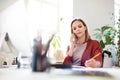 Businesswoman in wheelchair at the desk in her office. Royalty Free Stock Photo