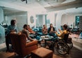 Businesswoman in wheelchair having business meeting with team at modern office. A group of young freelancers agree on