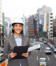 Businesswoman in white helmet with clipboard Royalty Free Stock Photo