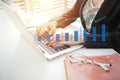 Businesswoman working on analytics and reporting company profit summary with laptop computer and glasses on desk Royalty Free Stock Photo