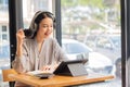 Businesswoman working in coffee shop remotely using and mobile tablet Royalty Free Stock Photo