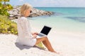 Businesswoman working with computer on the beach Royalty Free Stock Photo