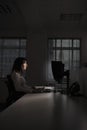 Businesswoman Working On Computer In Dark Office Royalty Free Stock Photo