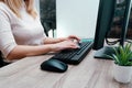 Businesswoman working on a computer from home during pandemic to prevent disease. Remote work. Selective focus. Hands, mouse, Royalty Free Stock Photo