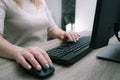 Businesswoman working on a computer from home during pandemic to prevent disease. Remote work. Selective focus. Hands, mouse, Royalty Free Stock Photo