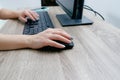 Businesswoman working on a computer from home during pandemic to prevent disease. Remote work. Selective focus. Hands, mouse, Royalty Free Stock Photo