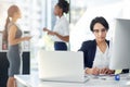 Businesswoman, working and computer in office, writing notes and laptop. Workplace, corporate and signing document at Royalty Free Stock Photo