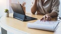 Businesswoman working with computer tablet and analyzing financial reports at desk. Royalty Free Stock Photo