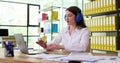 Businesswoman working at computer wearing antinoise headphones in office 4k movie slow motion