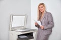 Businesswoman working on a copy machine at the office Royalty Free Stock Photo