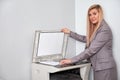 Businesswoman working on a copy machine at the office Royalty Free Stock Photo