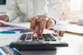 businesswoman working on desk in office and using calculator and laptop with pen for calculate budged money Royalty Free Stock Photo