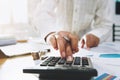 businesswoman working on desk in office and using calculator and laptop with pen for calculate budged money Royalty Free Stock Photo