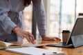 businesswoman working on desk office with using a calculator to calculate the numbers, finance accounting concept. Royalty Free Stock Photo