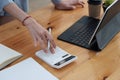 businesswoman working on desk office with using a calculator to calculate the numbers, finance accounting concept Royalty Free Stock Photo