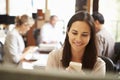 Businesswoman Working At Desk Using Mobile Phone Royalty Free Stock Photo