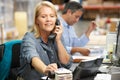 Businesswoman Working At Desk In Warehouse Royalty Free Stock Photo