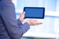 Businesswoman working on digital tablet outdoor over building background