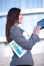 Businesswoman working on digital tablet outdoor over building background