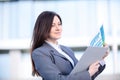 Businesswoman working on digital tablet outdoor over building background