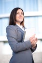 Businesswoman working on digital tablet outdoor over building background