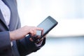 Businesswoman working on digital tablet outdoor over building background