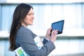 Businesswoman working on digital tablet outdoor over building background