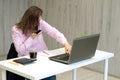 Businesswoman working at her desk in office. Woman talking on the phone and sitting in front of computer monitor Royalty Free Stock Photo