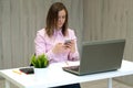 Businesswoman working at her desk in office. Woman talking on the phone and sitting in front of computer monitor Royalty Free Stock Photo