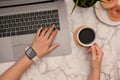 A businesswoman working at her office desk, using laptop while sipping coffee. top view Royalty Free Stock Photo