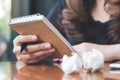 A businesswoman working and holding a white blank notebook with screwed up papers on table Royalty Free Stock Photo