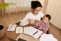 businesswoman working at home with her little child girl Royalty Free Stock Photo