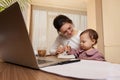 businesswoman working at home with her little child girl Royalty Free Stock Photo