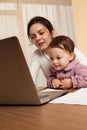 businesswoman working at home with her little child girl Royalty Free Stock Photo