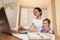 businesswoman working at home with her little child girl Royalty Free Stock Photo