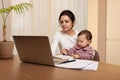 businesswoman working at home with her little child girl Royalty Free Stock Photo