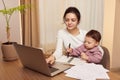 businesswoman working at home with her little child girl Royalty Free Stock Photo