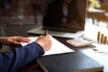 Businesswoman working with income statement document on the wood table.Business concept