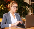 Businesswoman Working On Laptop In Coffee Shop. Young business woman uses laptop in cafe.Lifestyle and business concept. Royalty Free Stock Photo