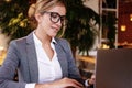 Businesswoman Working On Laptop In Coffee Shop. Young business woman uses laptop in cafe.Lifestyle and business concept. Royalty Free Stock Photo